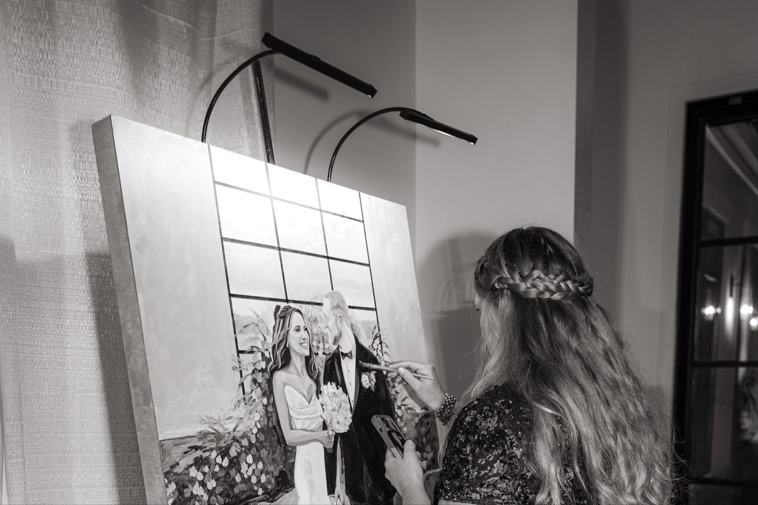 Jamie Wells creating a custom wedding painting during the reception.